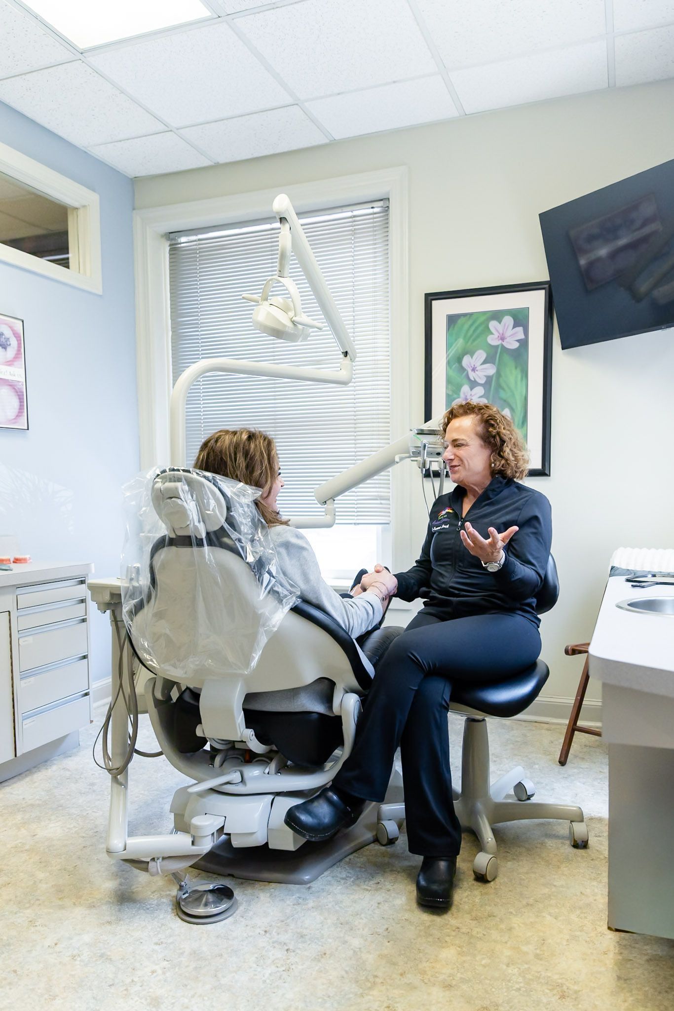 Two women talking in a dental exam room