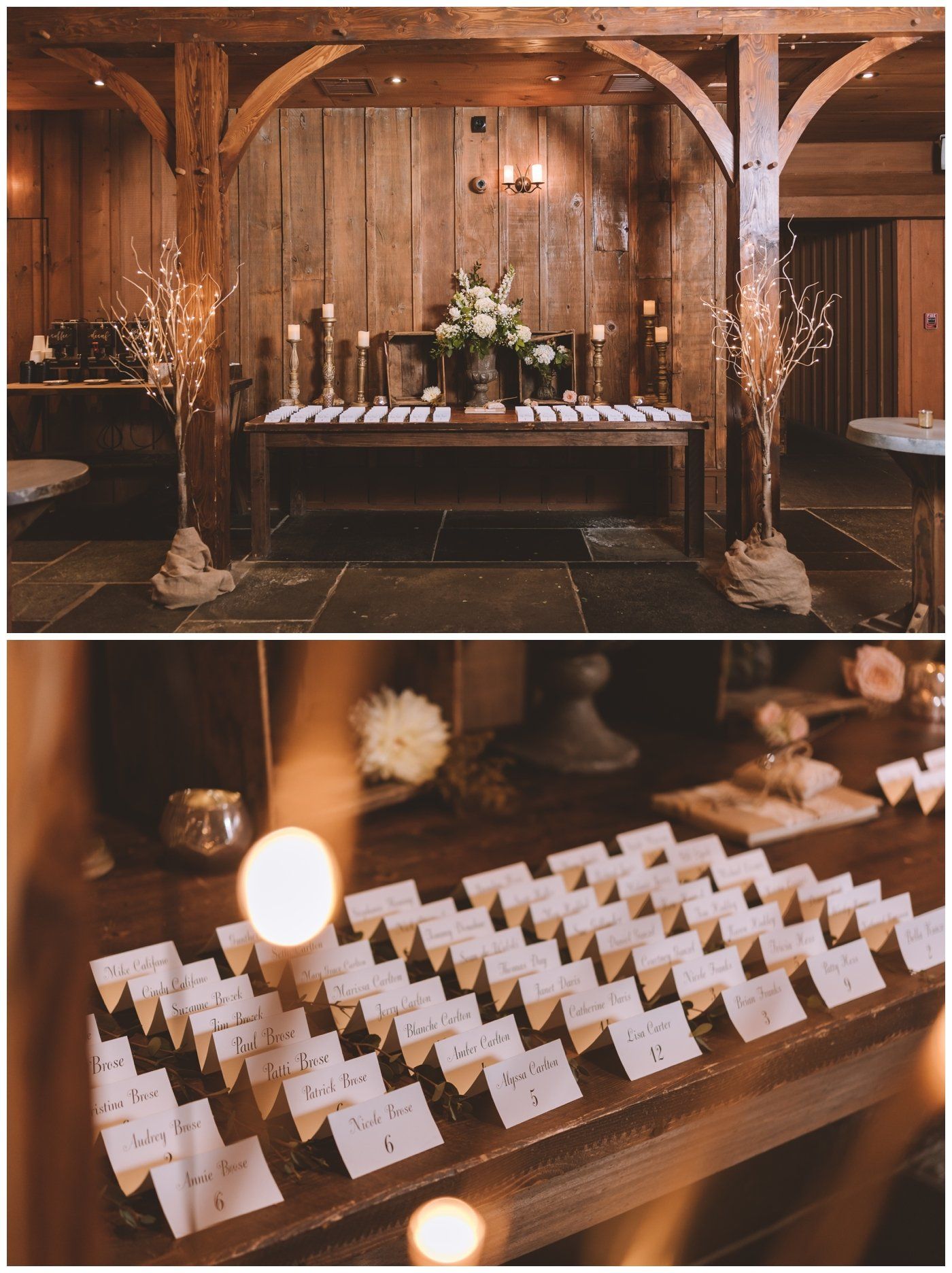 Rustic wooden reception table with candles, flowers, and rows of place cards in a warmly lit venue
