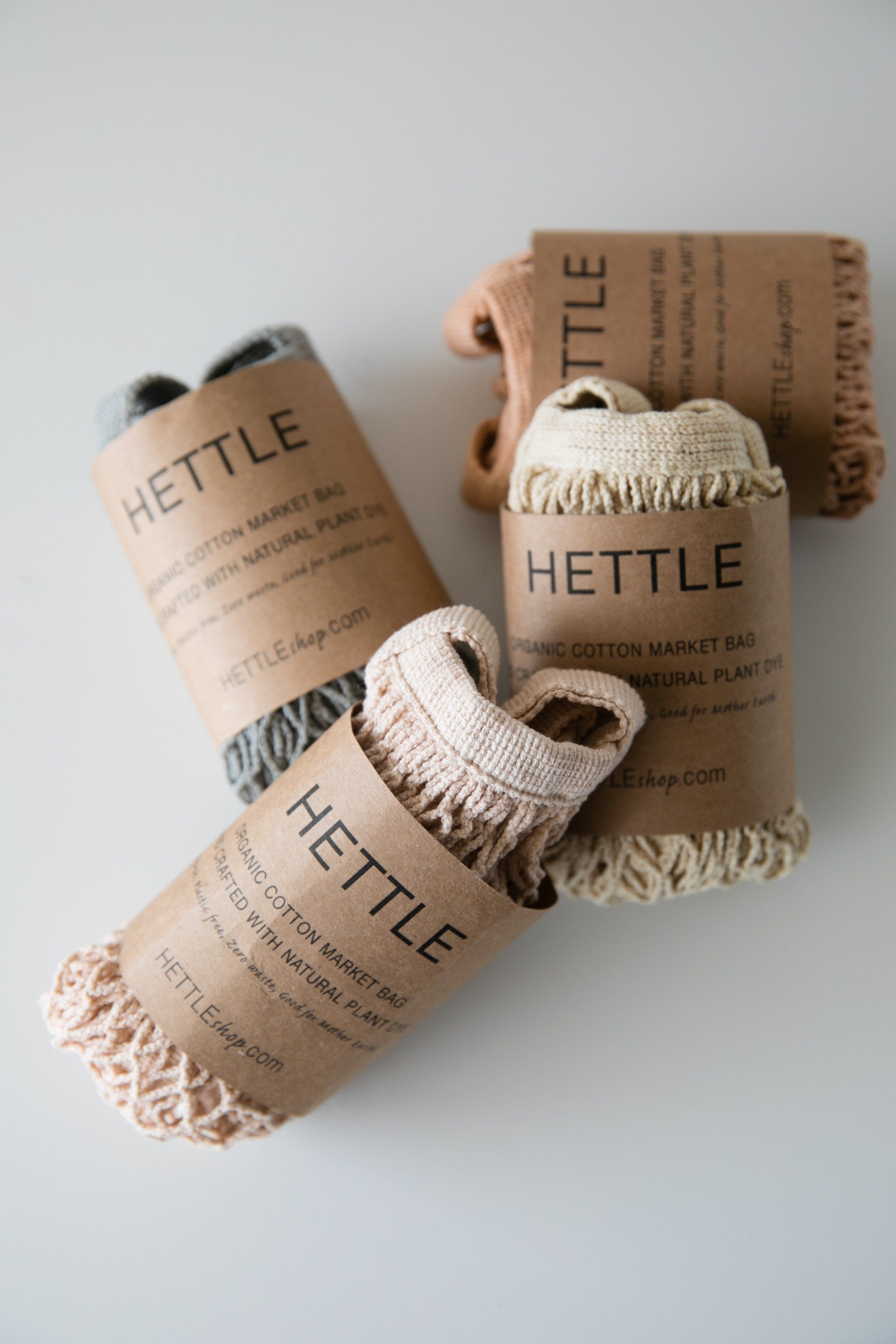 Three woven storage baskets with rope handles, labeled HETTLE, on a light gray surface