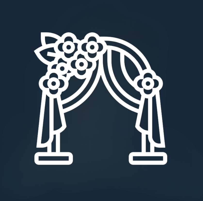 White wedding arch with draped curtains and floral arrangements on a dark blue background