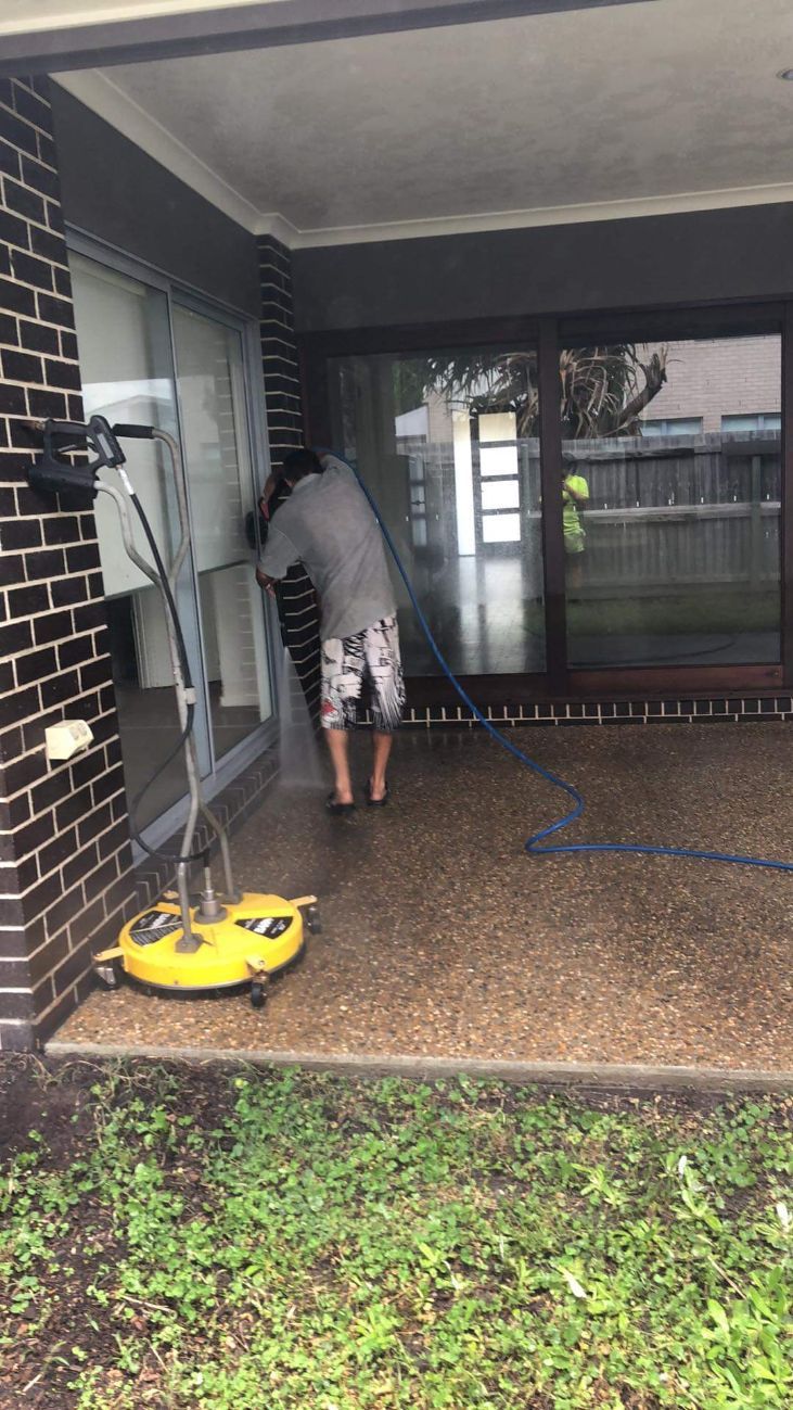 Man Cleaning Patio Using Pressure Washer — Cleaners in Sunshine Coast, QLD