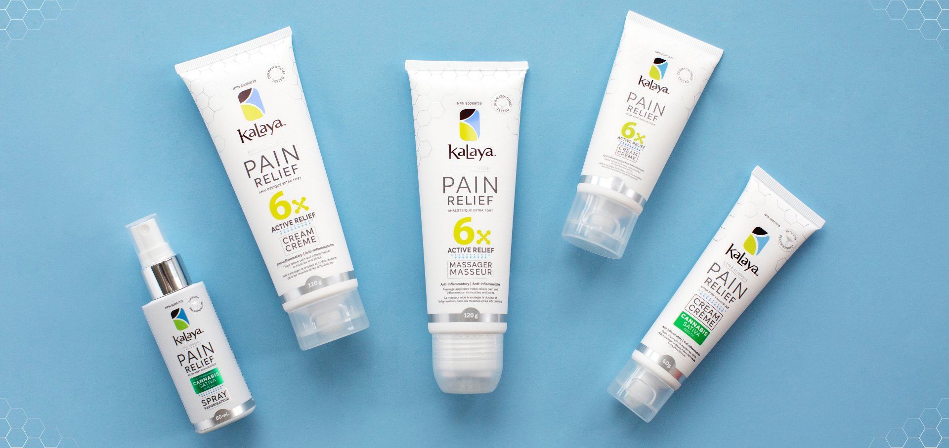A group of bottles of pain relief products are sitting on a blue surface.