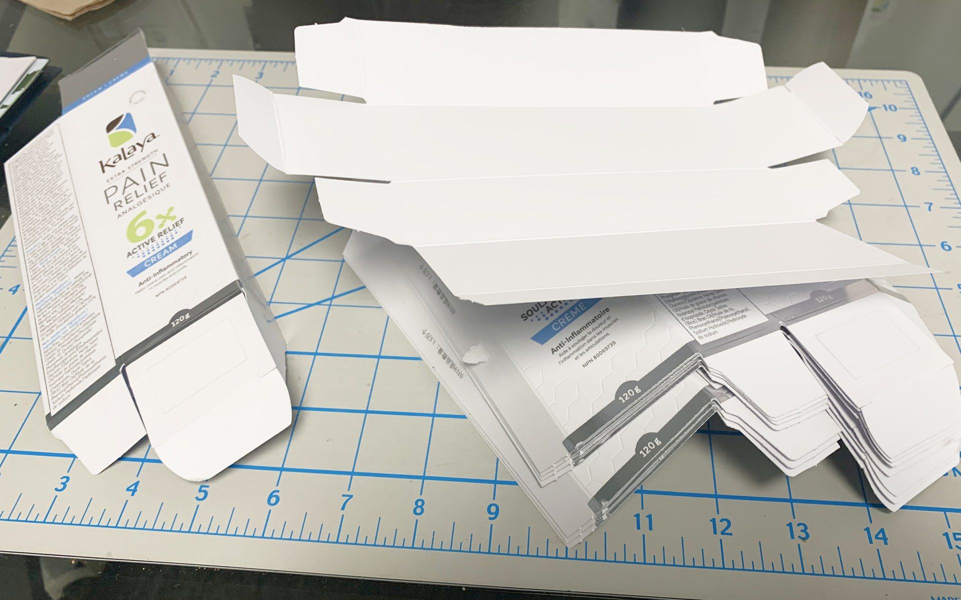 A bunch of boxes are sitting on a cutting mat