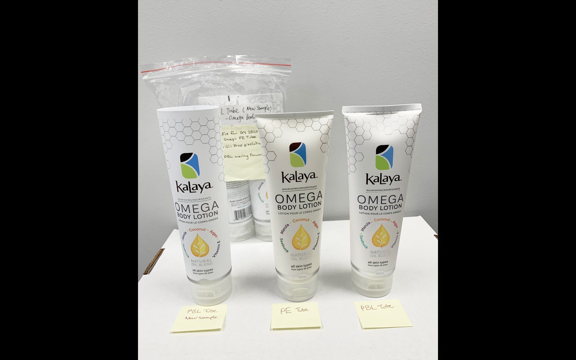 Three bottles of omega body lotion are sitting on a table.