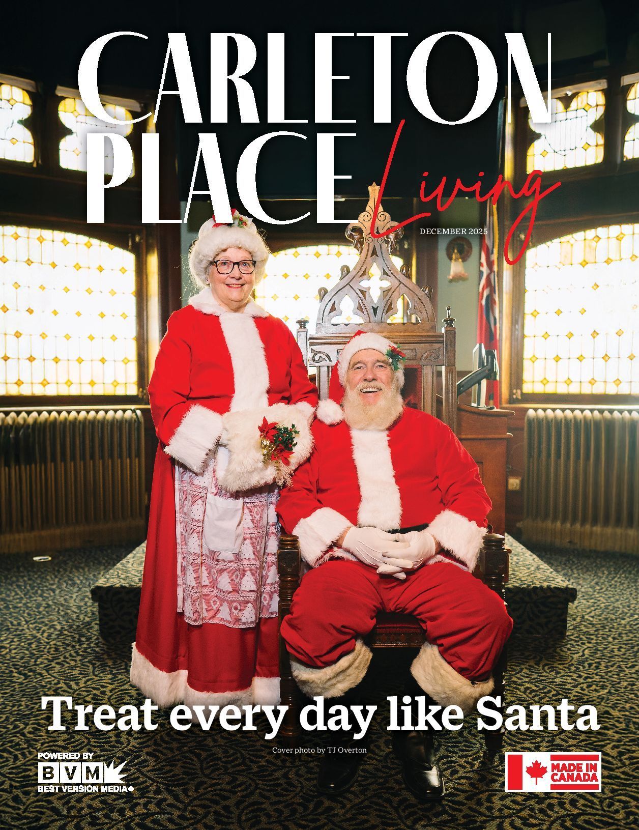Two Santa-clad people sit and stand in a festive lobby with the text “Treat every day like Santa.”
