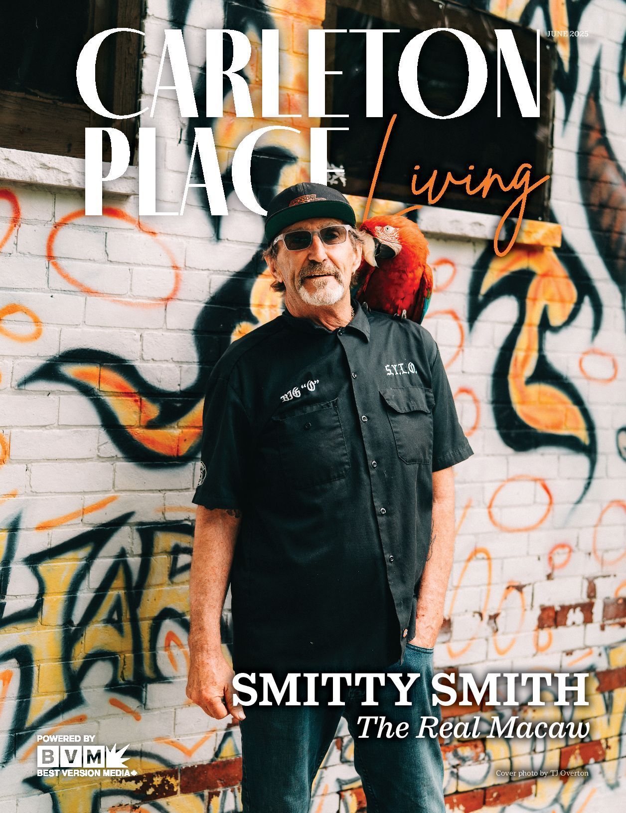 Man standing before graffiti wall with “CARLETON PLACE living” and “SMITTY SMITH The Real McCoy” text overlaid