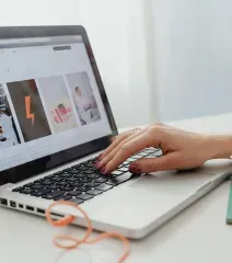 Laptop displaying a marketing concept screen with icons, charts, and words like branding, success, product, and strategy