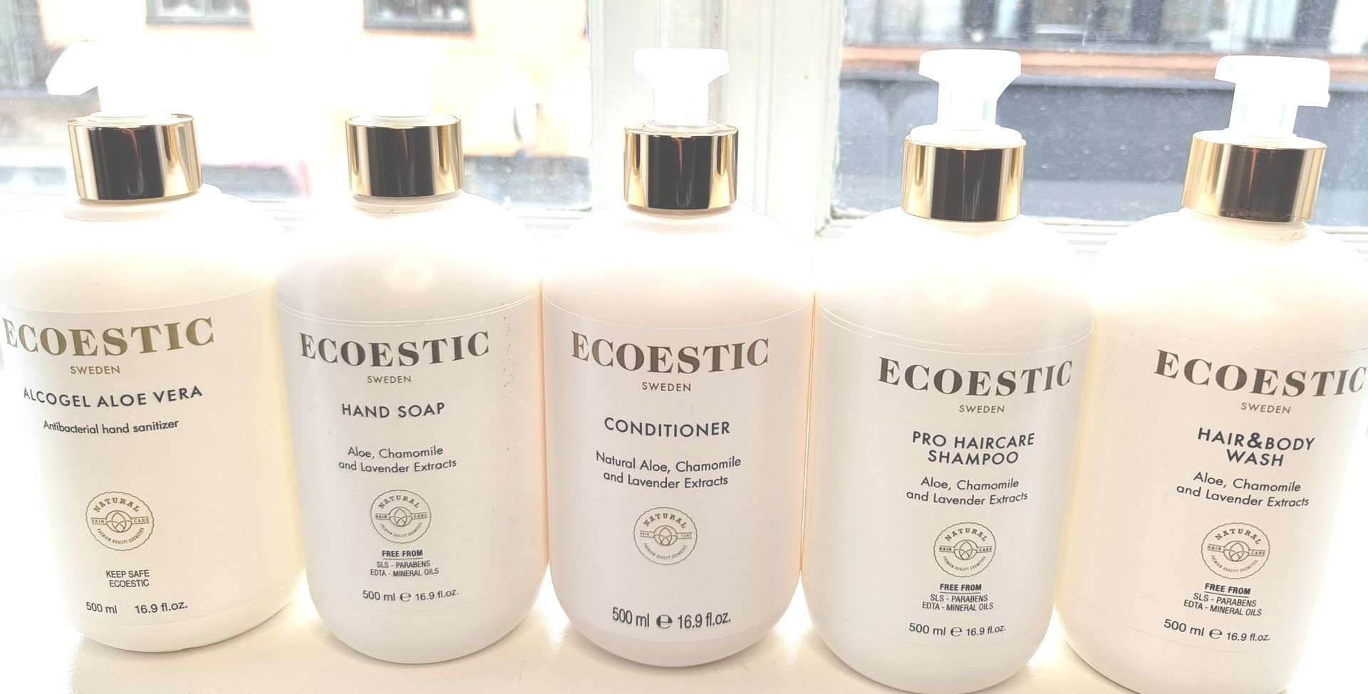 Five white Foersome bottles lined up on a shelf in a bright store display