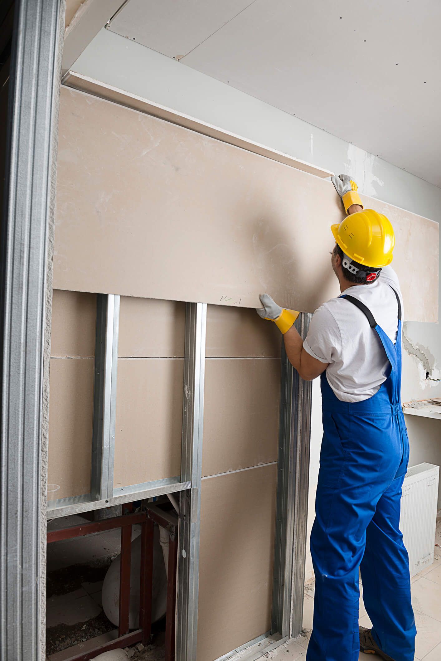 Contractor installing drywall in a Lakewood, CO home