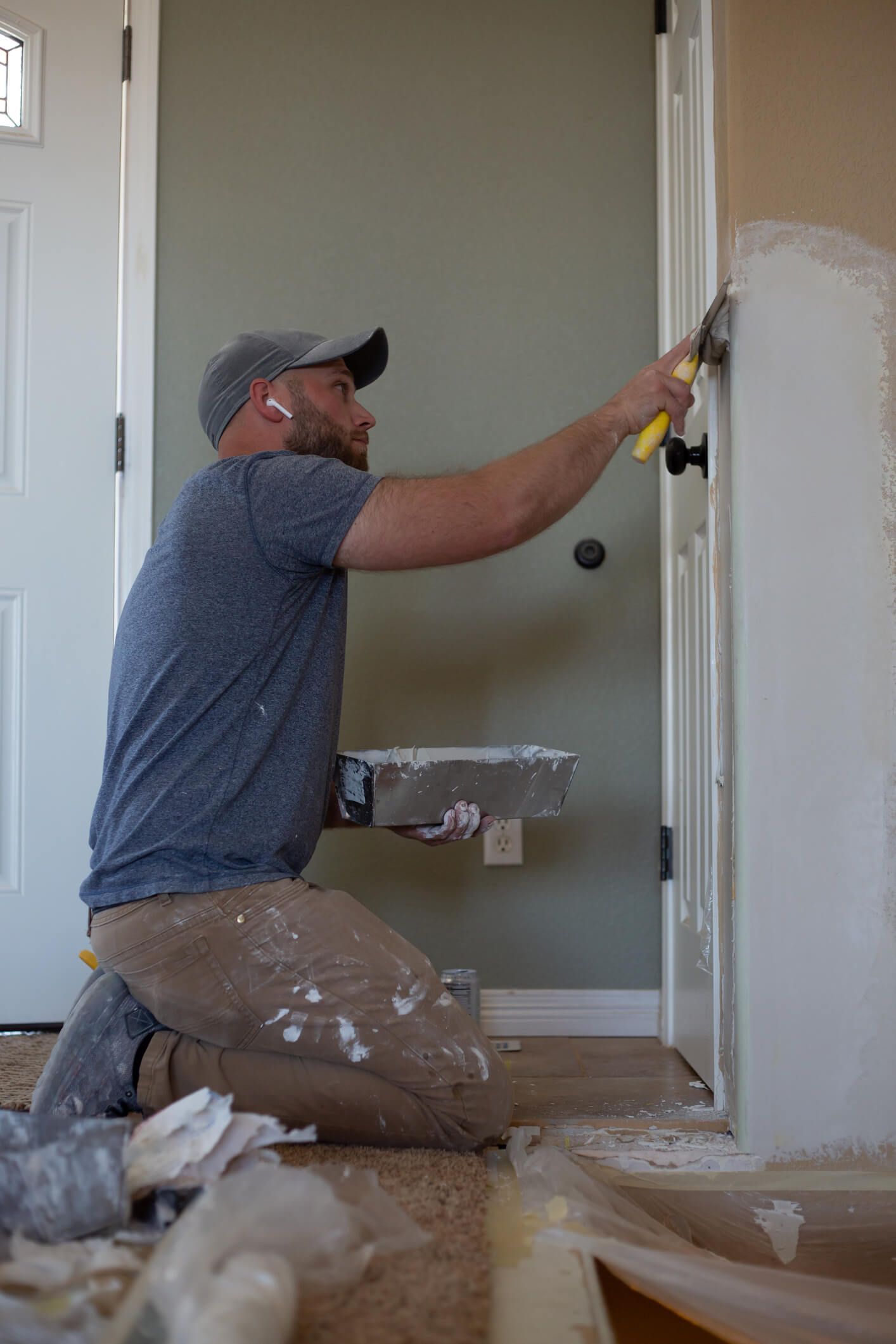 Contractor repairing damaged drywall in a Lakewood, Co home