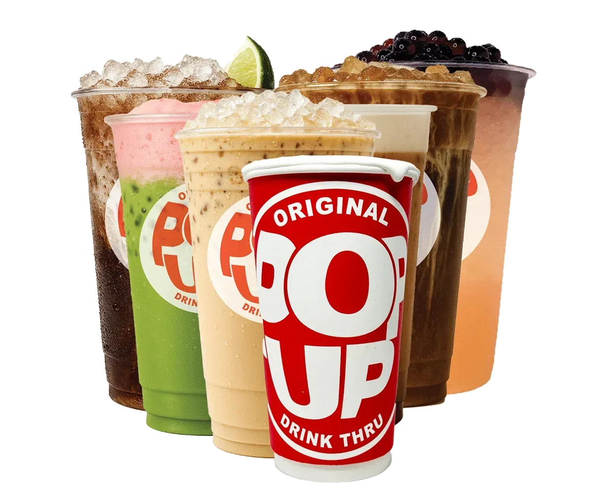 Assorted colorful drinks in branded cups with whipped cream and fruit toppings