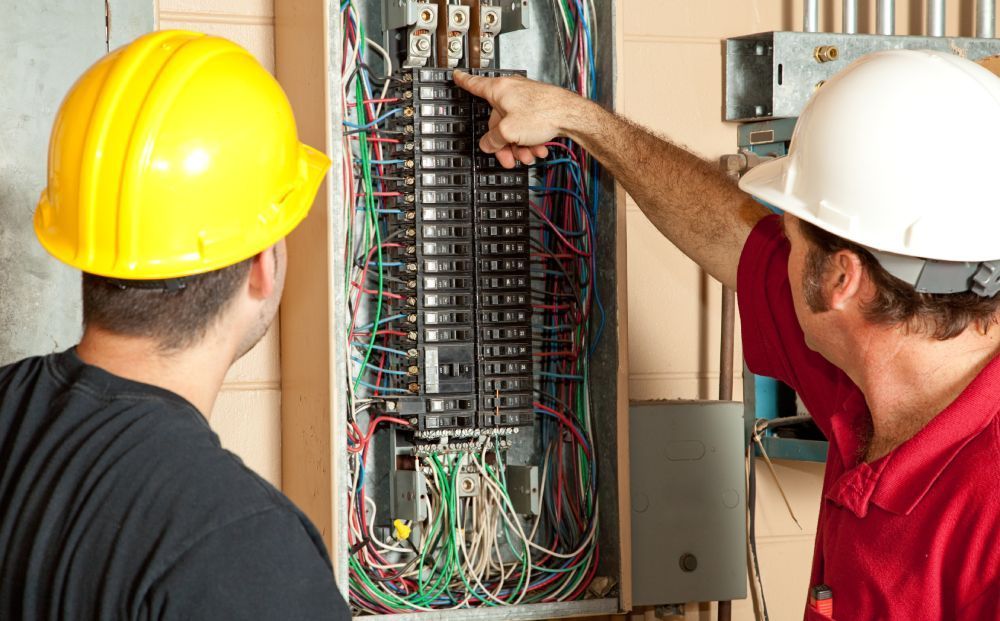 Electricians checking breaker panel