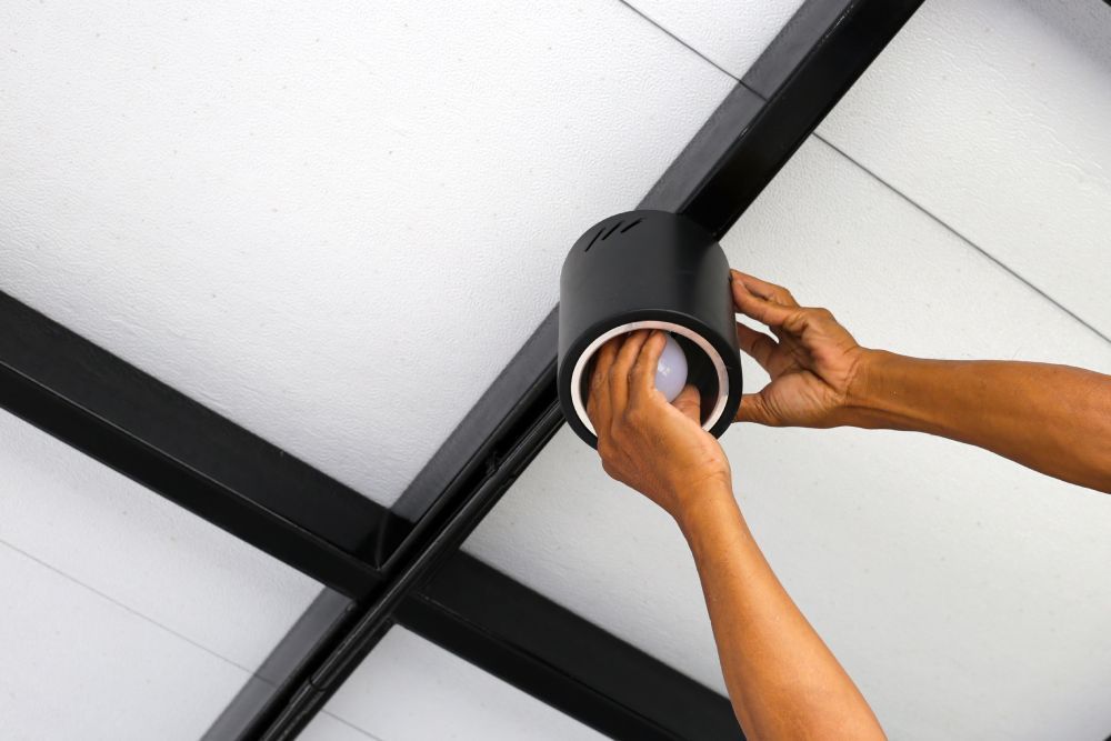 Electrician installing LED lights along residential stairs