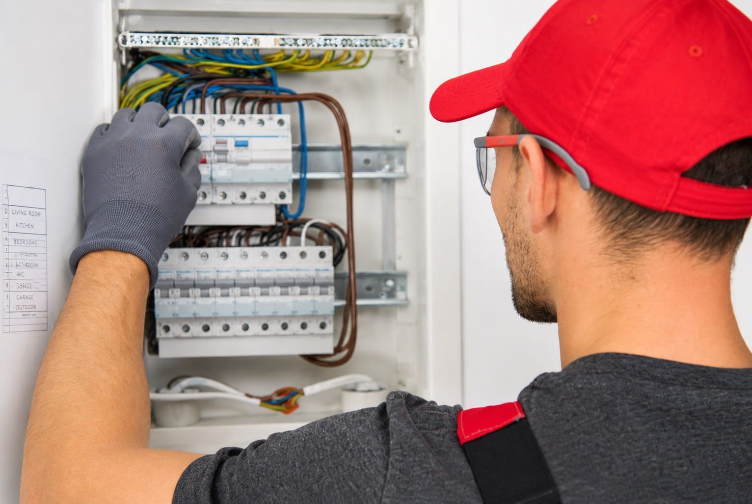 Electrician inspecting a home circuit breaker panel