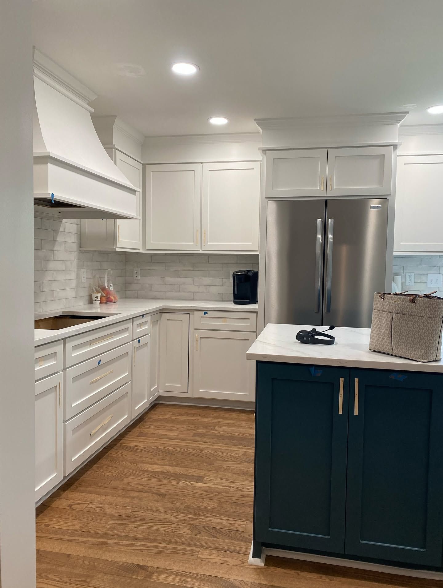 Blue kitchen island with white countertop in a modern open-plan kitchen