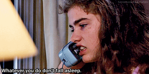 Woman on a phone, looking concerned. She has long, curly hair and says, 