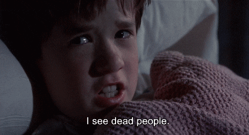 A young boy in bed, looking scared, says 