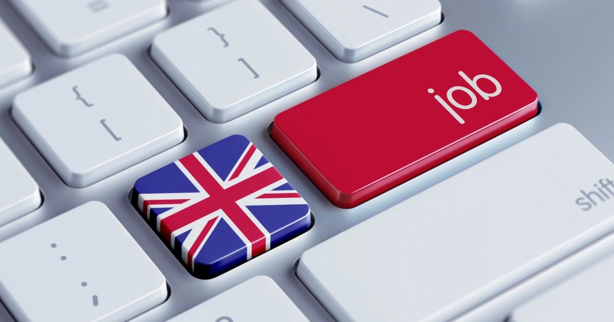 Union Jack key and red “job” key on a white keyboard