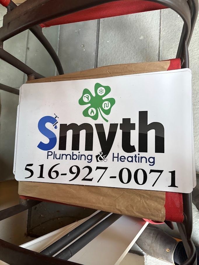 Smith Plumbing & Heating sign with phone number 516-927-0071 on a chair
