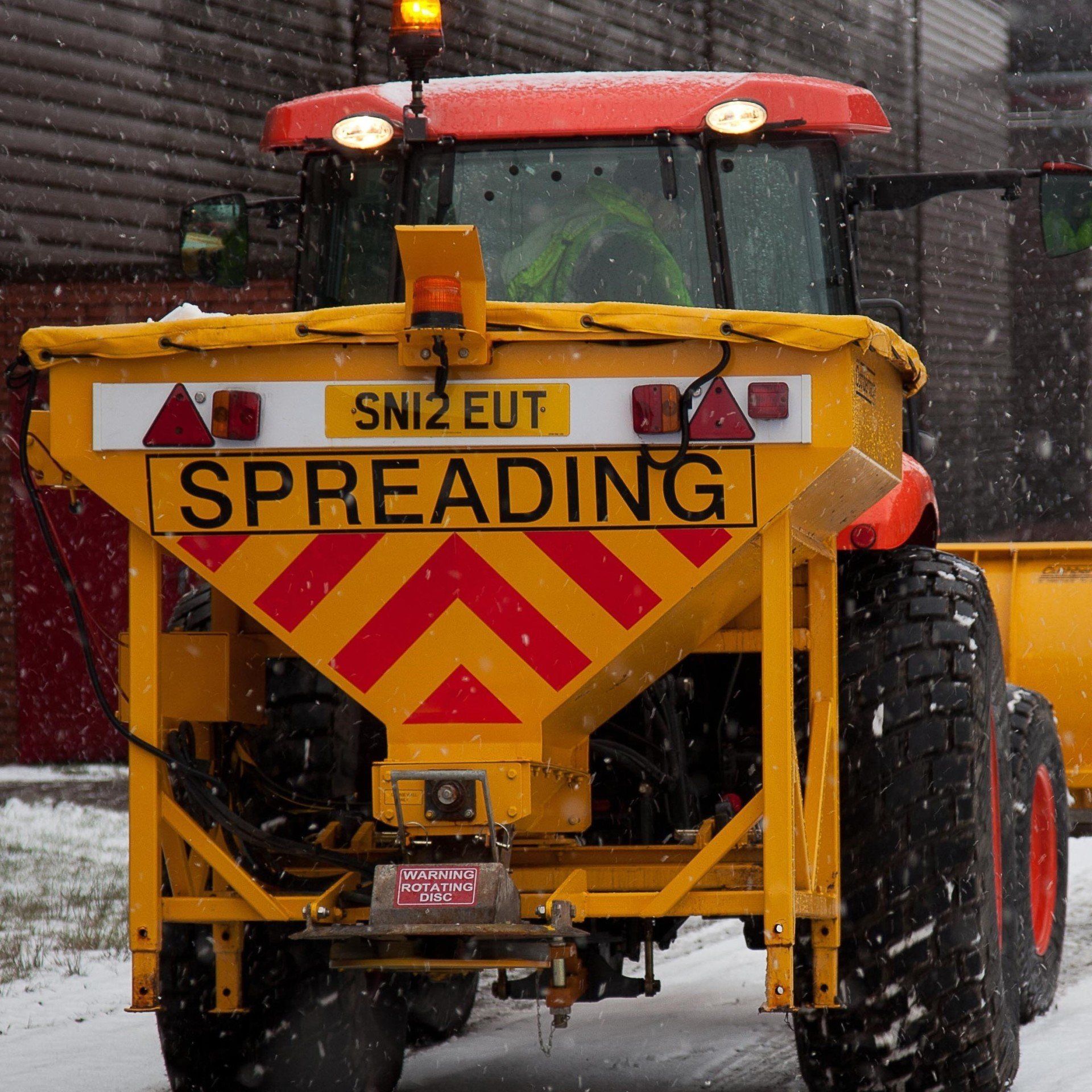 Grit spreader attached to a tractor