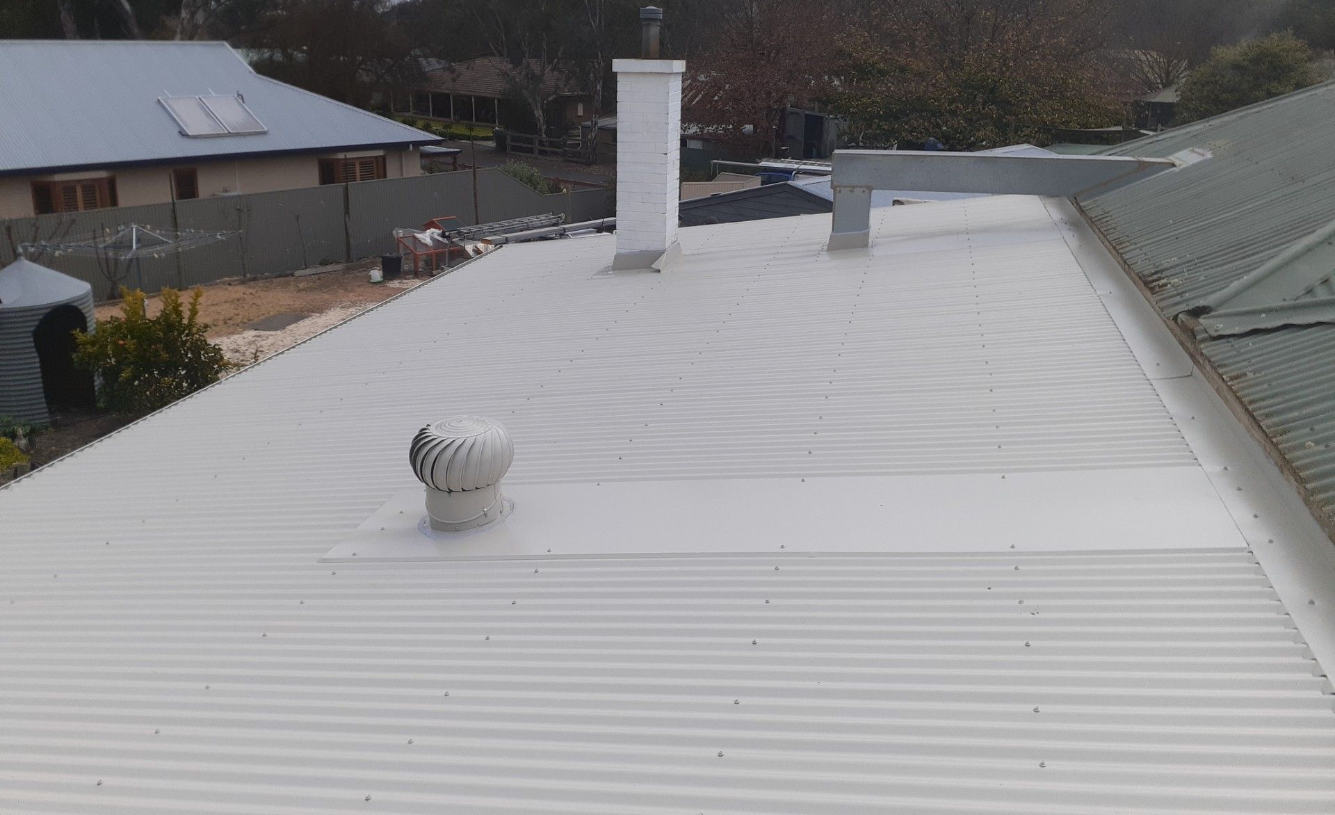Professional whirlybird installation on a metal roof in the Adelaide Hills