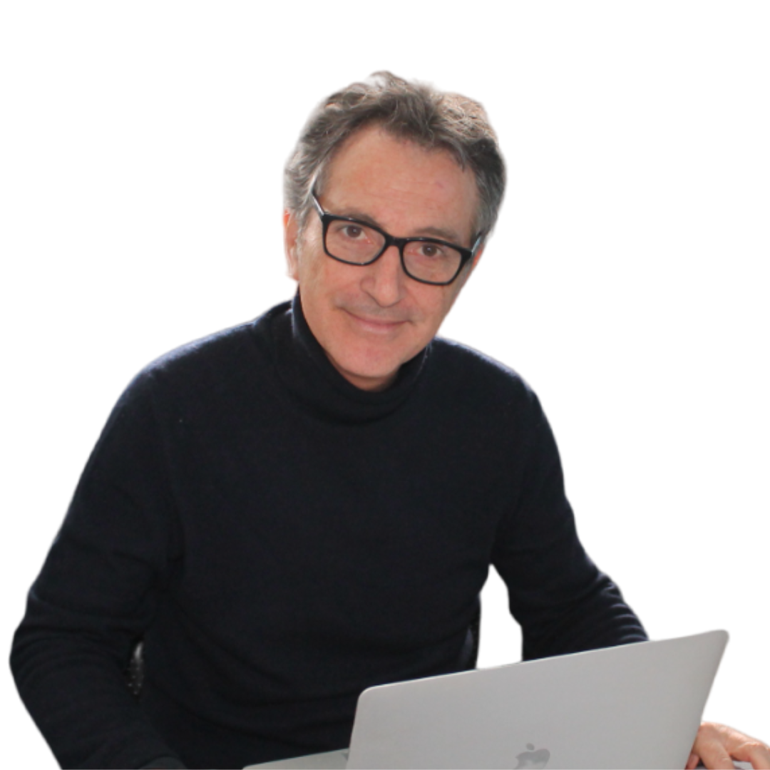 a man wearing glasses is sitting in front of a laptop