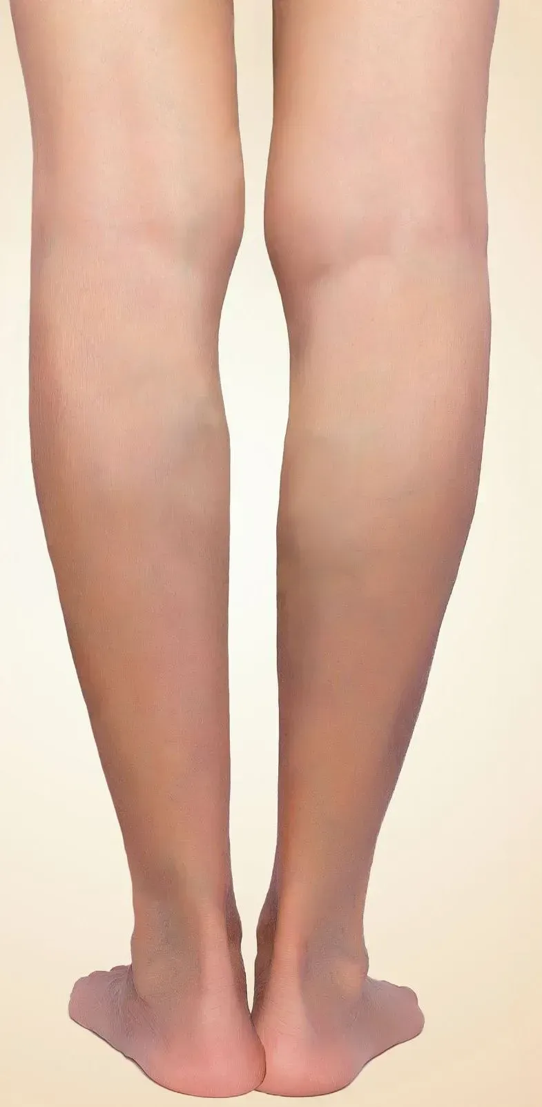 Back view of bare lower legs and feet standing together on a plain background
