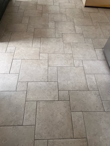 A close up of a tiled floor in a kitchen.