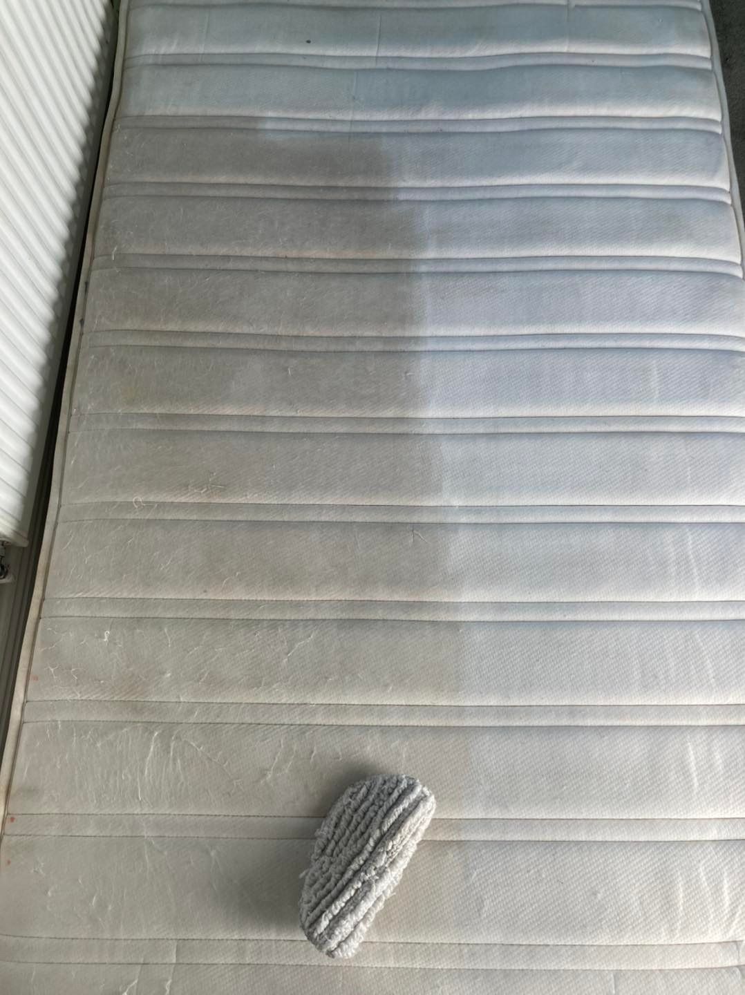 A mattress with a brush on top of it.