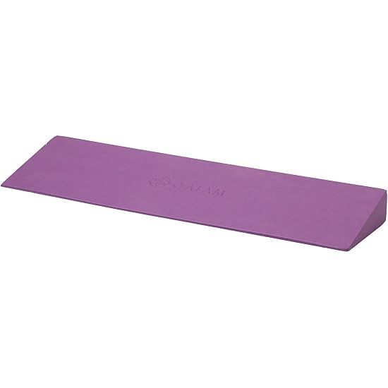 Purple wedge-shaped foam yoga block on a white background
