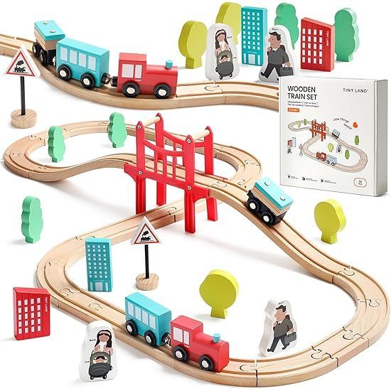 Wooden toy train set with colorful cars, trees, buildings, and a red bridge on a winding track