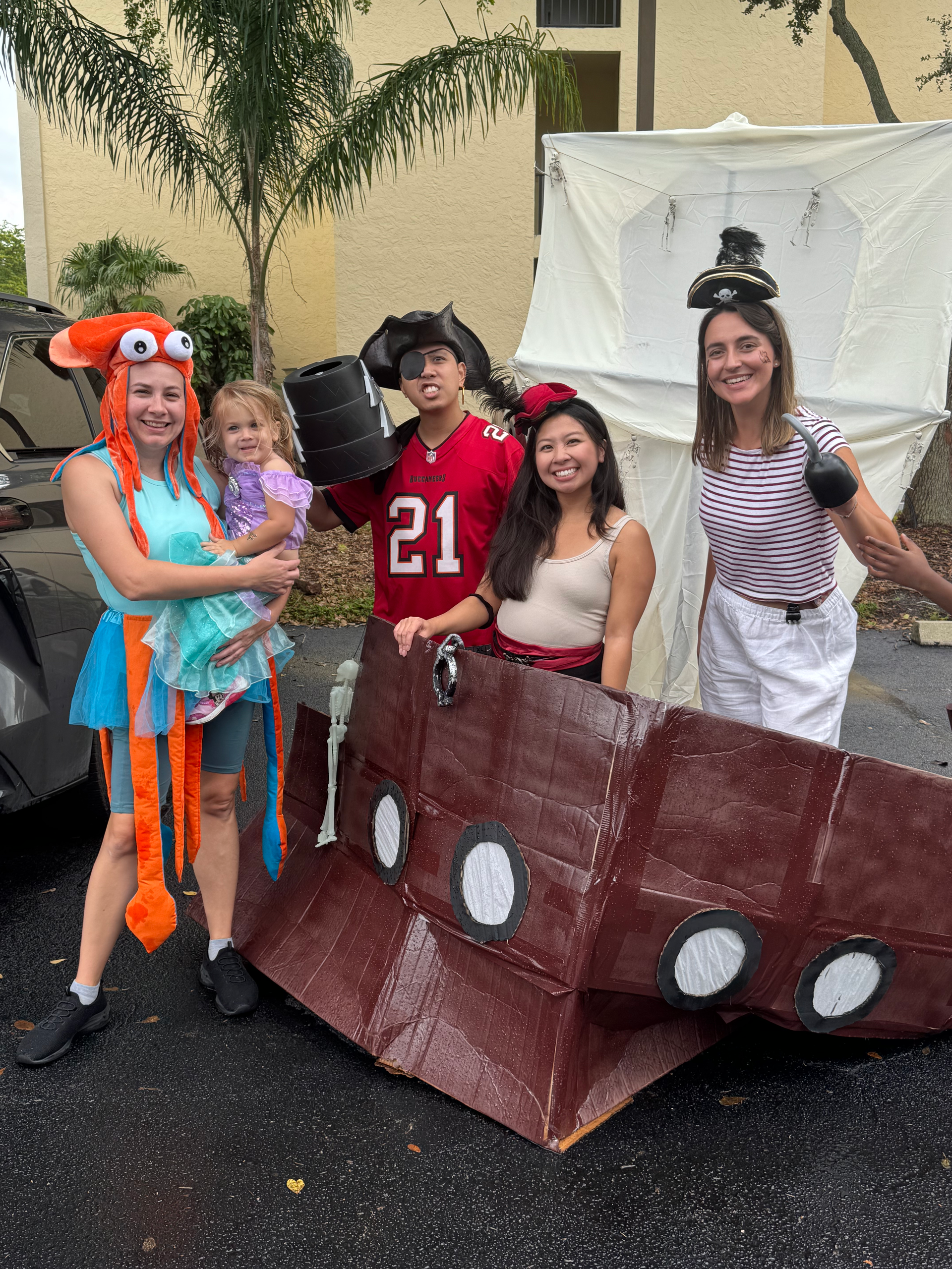 A group of people dressed in pirate costumes are posing for a picture.
