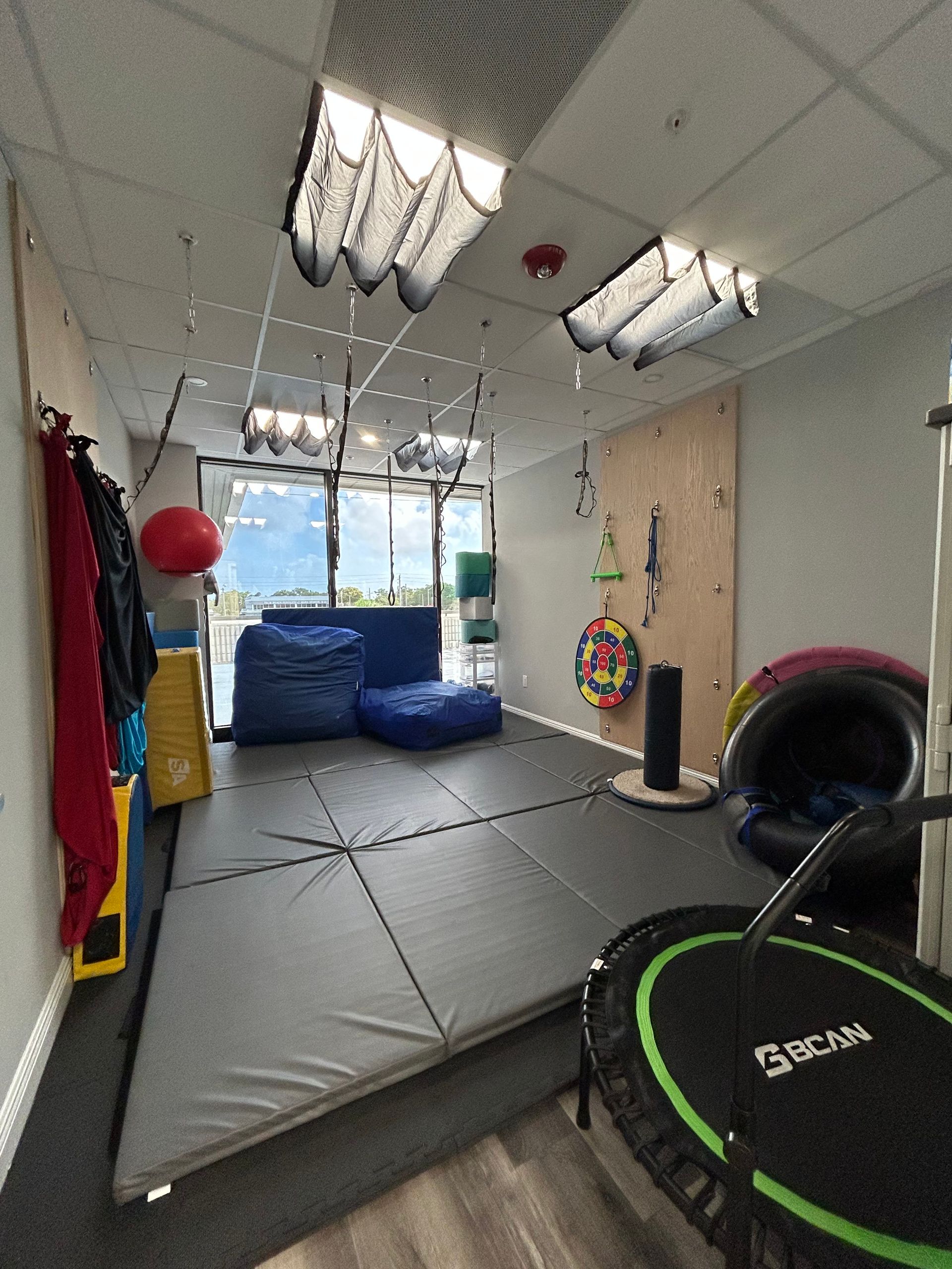A room filled with lots of toys and exercise equipment.