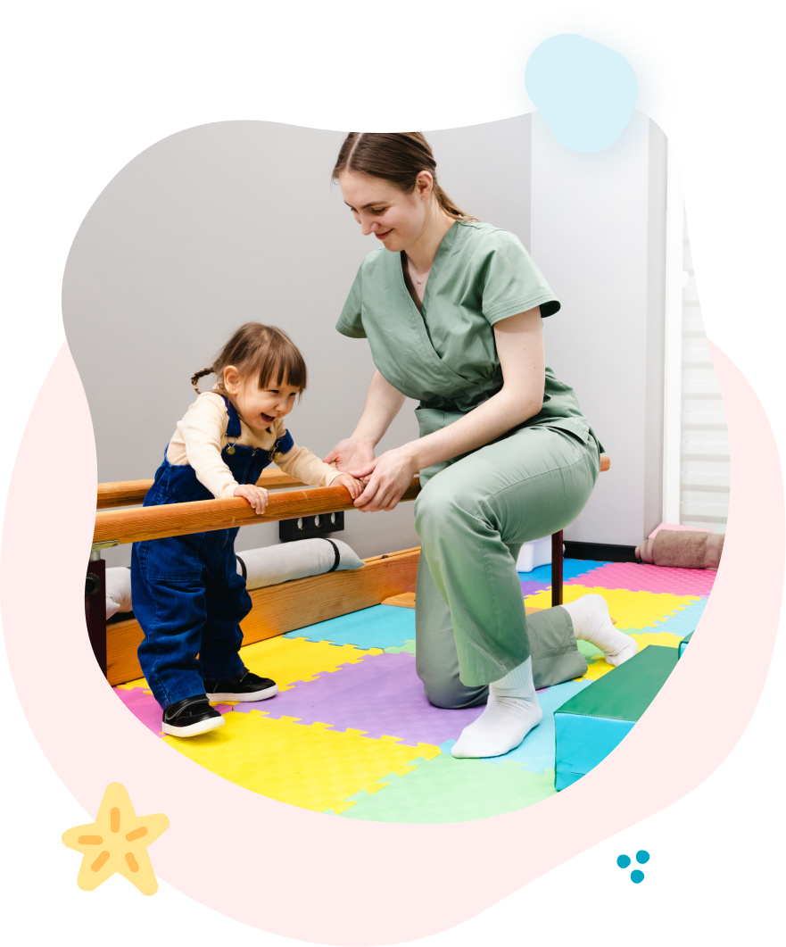 Therapist and child practicing balance on parallel bars in a colorful pediatric therapy room
