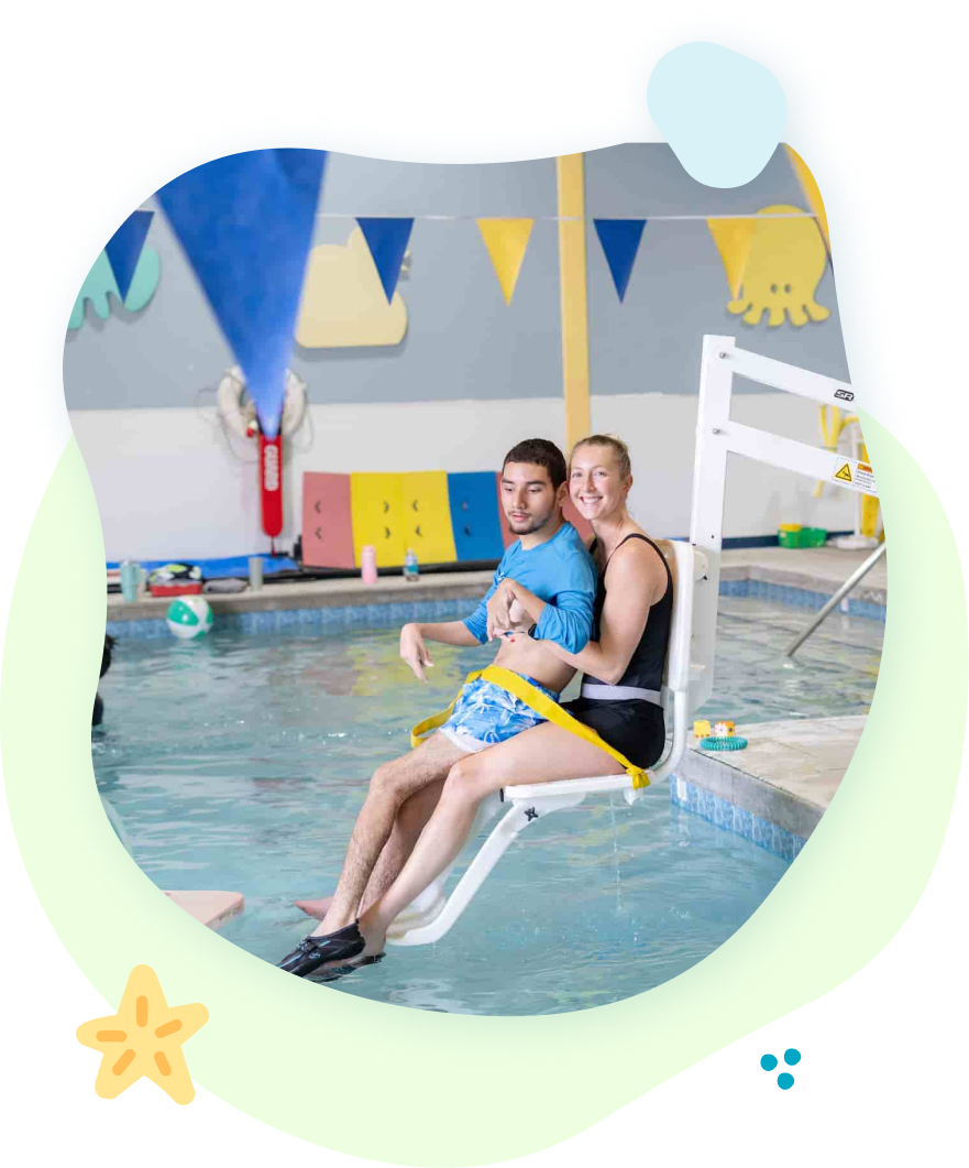 A man and a woman are sitting in a lifeguard chair in a swimming pool.