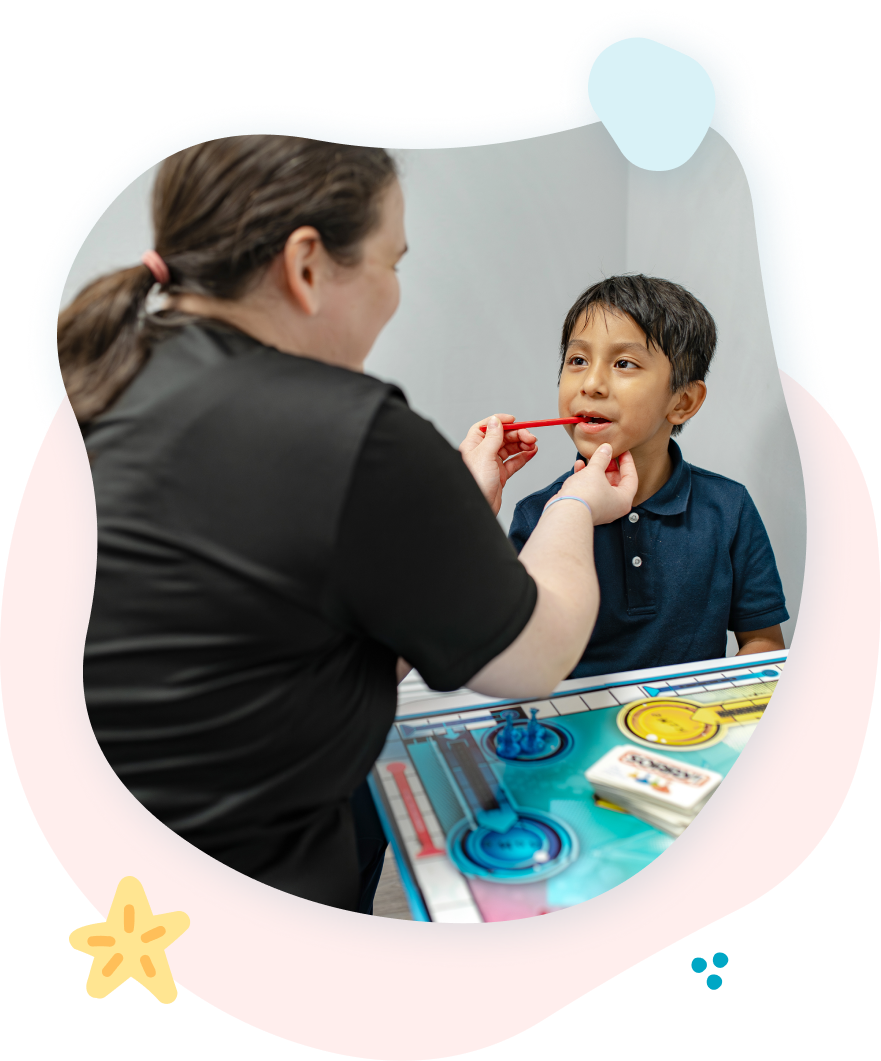 A woman is playing with a child who is playing with blocks.