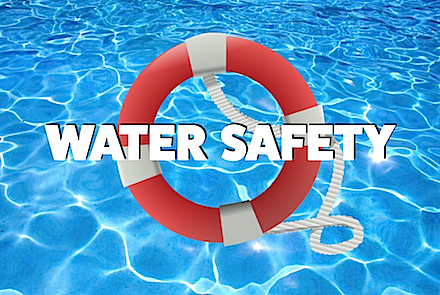 A life preserver in a swimming pool with the words water safety below it