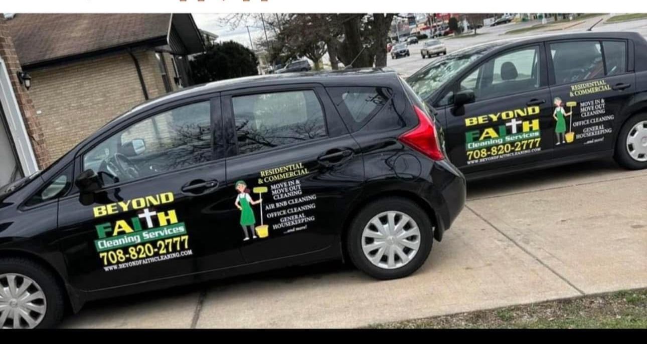 Two black service vans with Beyond Faith lawn care branding parked in a driveway.