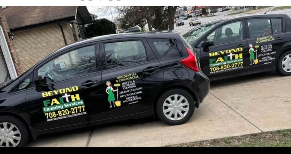 Two black service vans with Beyond Faith lawn care branding parked in a driveway.