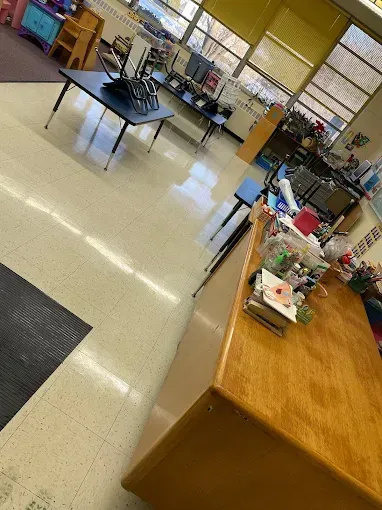 Science classroom with lab tables, computers, and supplies near large windows
