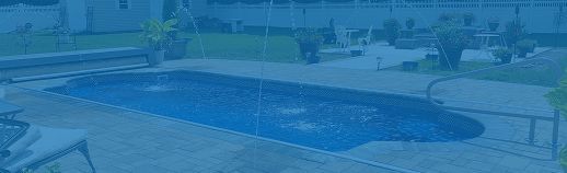 Backyard swimming pool with a blue cover, patio chairs, and plants along the deck