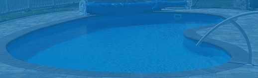Blue swimming pool with a metal handrail and a curved diving board at the edge