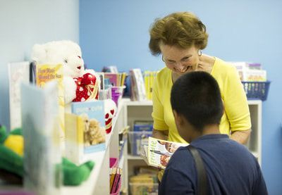 Volunteer reading with child