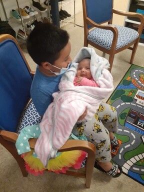 Little Boy Holding Baby