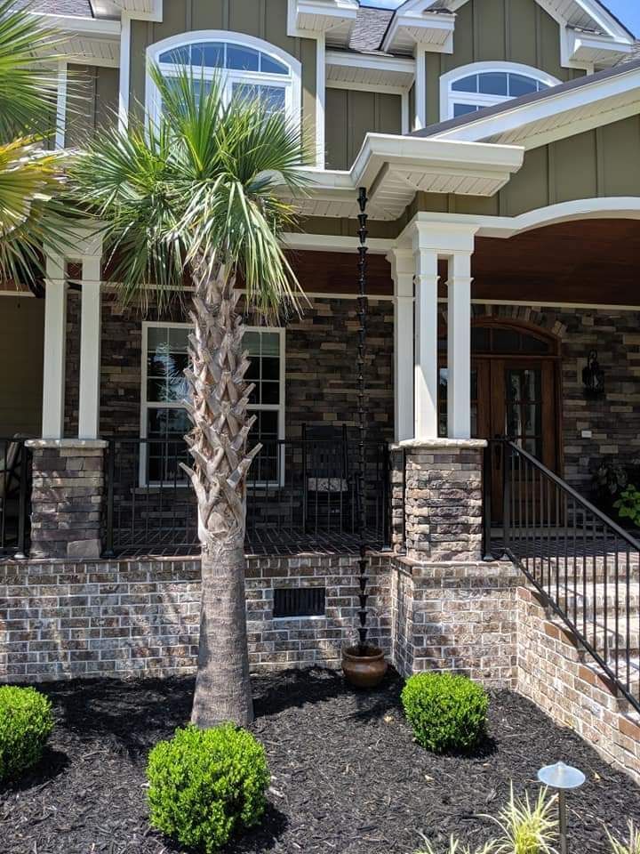 A large house with a palm tree in front of it.