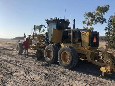 Man Beside Grader Truck — Plant Operator Courses Port Stephens