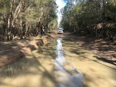 White Ute Driving on a Flooded Dirt Road — Verification of Competency Port Stephens