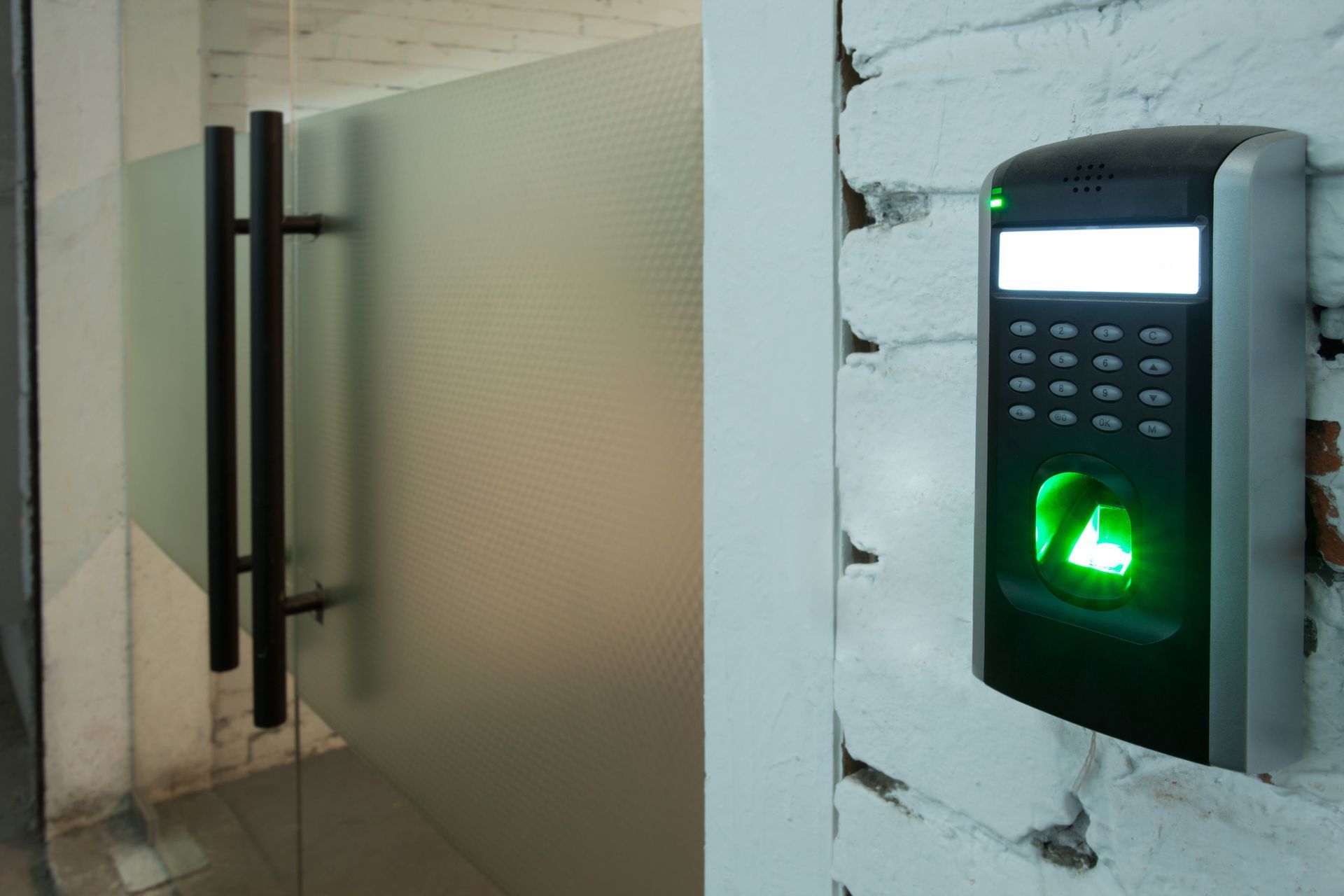 Digital fingerprint reader on a wall facilitating access control systems maintenance in a building.