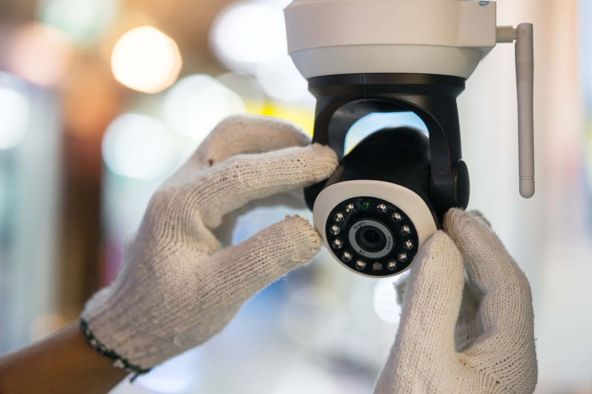 A man is installing a CCTV system.