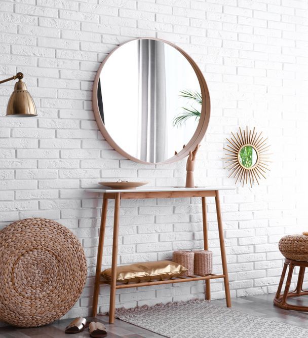 Round Mirror is Hanging on a White Brick Wall — Glass in Bulli, NSW